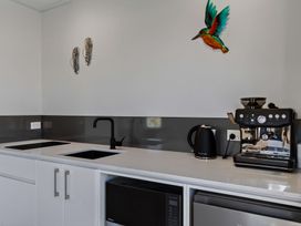 A kitchen with a coffee machine and kettle at Mangawhai Holiday Home in Mangawhai