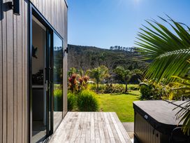 An outdoor area with a hot tub and plants at Mangawhai Holiday Home in Mangawhai