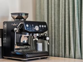 A coffee machine on a countertop at Mangawhai Holiday Home Mangawhai