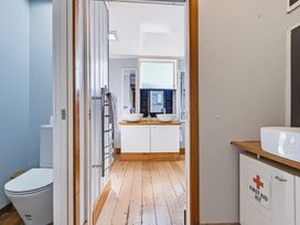 A bathroom with sink and toilet at Hannan House - Whitianga Holiday Home