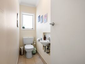 A bathroom featuring a toilet and sink at Ohana - Papamoa Holiday Home, Papamoa