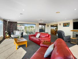 A living room with sofas and a coffee table at Ohana - Papamoa Holiday Home, Papamoa