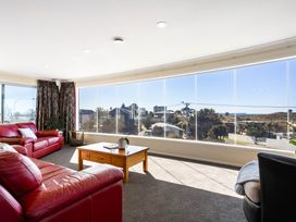 A living room with a view of the outside at Ohana - Papamoa Holiday Home Papamoa