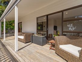 An outdoor patio area with seating and a table at Skipper’s view - Onemana Holiday Home in Onemana