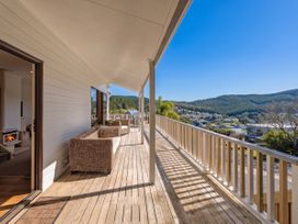 A deck with outdoor furniture at Skipper’s view - Onemana Holiday Home Onemana