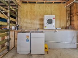 A laundry room with a washing machine and dryer at Skipper’s view - Onemana Holiday Home in Onemana