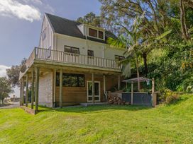 A house with a deck and garden at Skipper’s view - Onemana Holiday Home Onemana