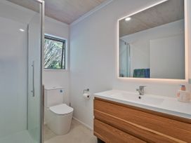 A bathroom with shower and sink at Skipper’s view - Onemana Holiday Home in Onemana