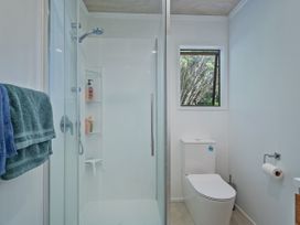 A shower and toilet in a bathroom at Skipper’s view - Onemana Holiday Home, Onemana