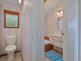 A bathroom with a toilet, sink, and bathtub at Skipper’s view - Onemana Holiday Home, Onemana