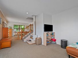 A living room with a sofa and television at Skipper’s view - Onemana Holiday Home in Onemana