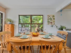A dining room with a table set for dinner at Skipper’s view - Onemana Holiday Home in Onemana