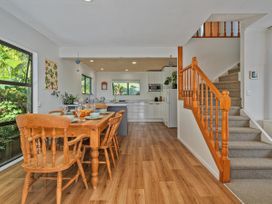 A dining room with a table and chairs at Skipper’s view - Onemana Holiday Home Onemana