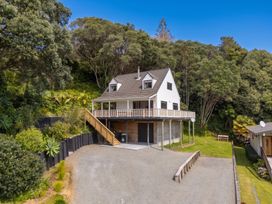 A house with a deck and garden at Skipper’s view - Onemana Holiday Home, Onemana