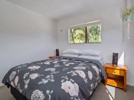 A bedroom with a bed and nightstand at Skippers View - Onemana Holiday Home, Onemana