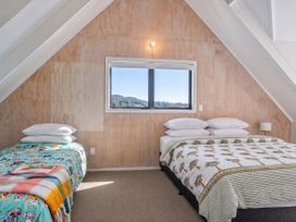 A bedroom with two beds and a window at Skippers View - Onemana Holiday Home, Onemana