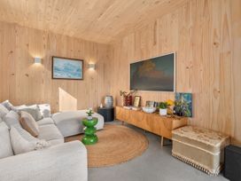 A living room with a sofa and a drawer unit at Peak Perspective - Wanaka Holiday Home, Wanaka
