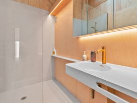 A bathroom with a sink and mirror at Peak Perspective - Wanaka Holiday Home in Wanaka
