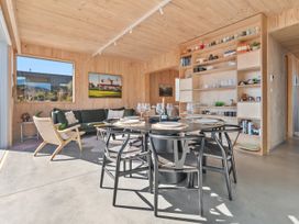 A dining room with a table and chairs at Peak Perspective - Wanaka Holiday Home Wanaka