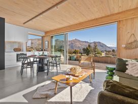 A dining area with a kitchen and sofa at Peak Perspective - Wanaka Holiday Home Wanaka