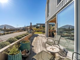 An outdoor patio with seating and planters at Peak Perspective - Wanaka Holiday Home in Wanaka