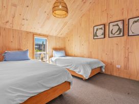 A bedroom with two beds and window at Peak Perspective - Wanaka Holiday Home, Wanaka
