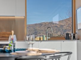 A kitchen with a sink and mountain view at Peak Perspective - Wanaka Holiday Home in Wanaka