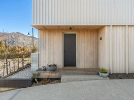 An entrance area with a door and planters at Peak Perspective - Wanaka Holiday Home in Wanaka