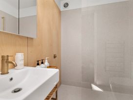 A bathroom with a sink and shower at Peak Perspective - Wanaka Holiday Home in Wanaka