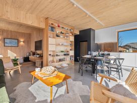 A living room with a table and chairs at Peak Perspective - Wanaka Holiday Home Wanaka