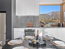 A kitchen with a dining table and mountain view at Peak Perspective - Wanaka Holiday Home, Wanaka