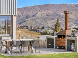 An outdoor patio with a table and chairs at Peak Perspective - Wanaka Holiday Home, Wanaka