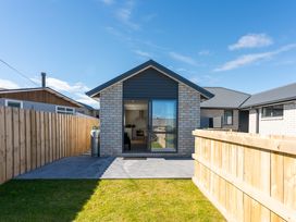 A house with a patio and fence at The Cozy Koha - Taupo Holiday Home in Taupo