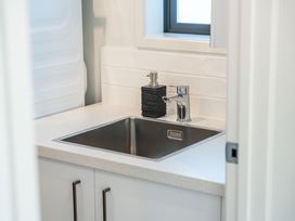 A laundry room with a sink and countertop at The Cozy Koha - Taupo Holiday Home Taupo