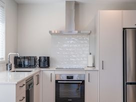 A kitchen with appliances and fixtures at The Cozy Koha - Taupo Holiday Home in Taupo