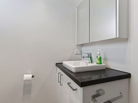 A bathroom with a sink and mirror at Starling - Mangawhai Heads Holiday Home in Mangawhai Heads