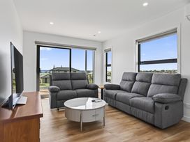 A living room with a sofa and coffee table at Starling - Mangawhai Heads Holiday Home Mangawhai Heads
