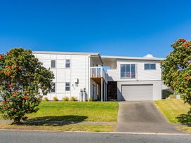 A house with a balcony and garage at Starling - Mangawhai Heads Holiday Home Mangawhai Heads