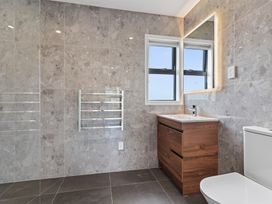 A bathroom with a sink and toilet at Starling - Mangawhai Heads Holiday Home, Mangawhai Heads