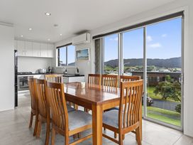 A kitchen with a dining table and chairs at Starling - Mangawhai Heads Holiday Home Mangawhai Heads