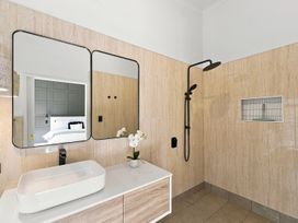 A bathroom with a shower and sink at The Black Barn - Whakatane Holiday Home Whakatane