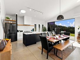 A kitchen with dining area and appliances at The Black Barn - Whakatane