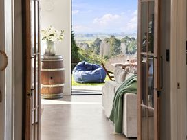 A living room with a view of the outdoors at The Black Barn - Whakatane Holiday Home Whakatane