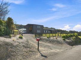 An exterior view of a house with a driveway and vehicle at The Black Barn - Whakatane