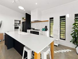 A kitchen with a modern design and appliances at The Black Barn - Whakatane Holiday Home, Whakatane