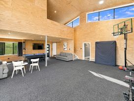 A game room with a basketball hoop and pool table at The Black Barn - Whakatane Holiday Home in Whakatane