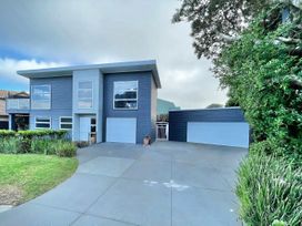 A house with a driveway and garages at Vinnie’s haven - Opunake Holiday Home