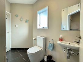 A bathroom with a toilet and sink at Vinnie’s haven - Opunake Holiday Home