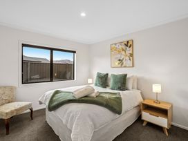 A bedroom with a bed and side table at Hosking Haven - Cromwell Holiday Home in Cromwell