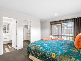 A bedroom with a bed and adjoining bathroom at Hosking Haven - Cromwell Holiday Home, Cromwell